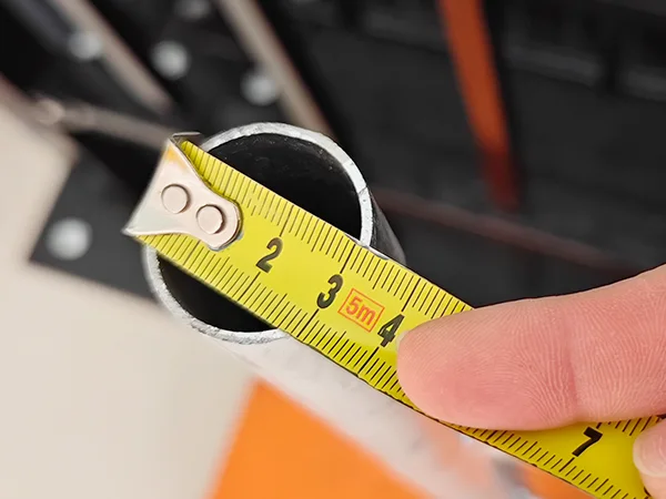 A QC worker is measuring the frame size of Galvanized New Zealand temporary fence.
