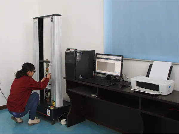 A QC worker is testing the tensile strength of steel wire.