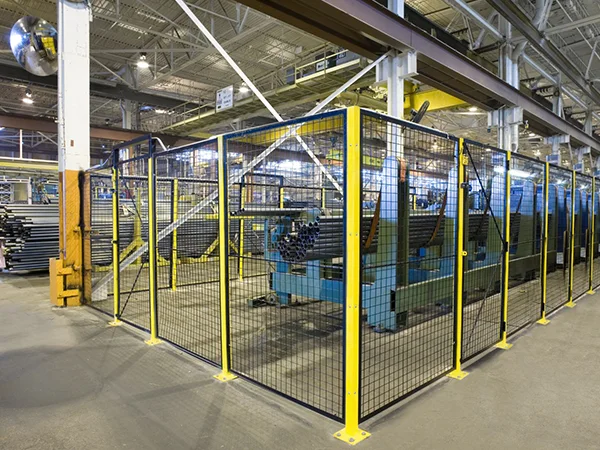 The machine guarding fences are installed surrounding the equipment.