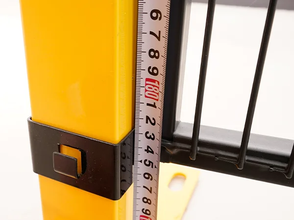 A QC worker is measuring the height of machine guarding fence.