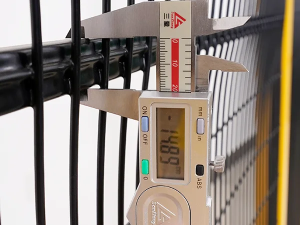 A QC worker is measuring the rail size of machine guarding fence.