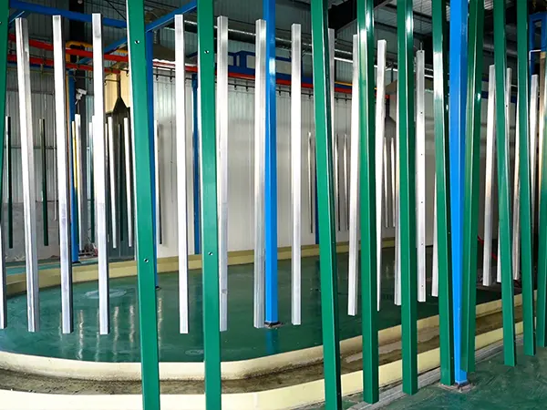 The green square posts are hanging on the powder coating line.