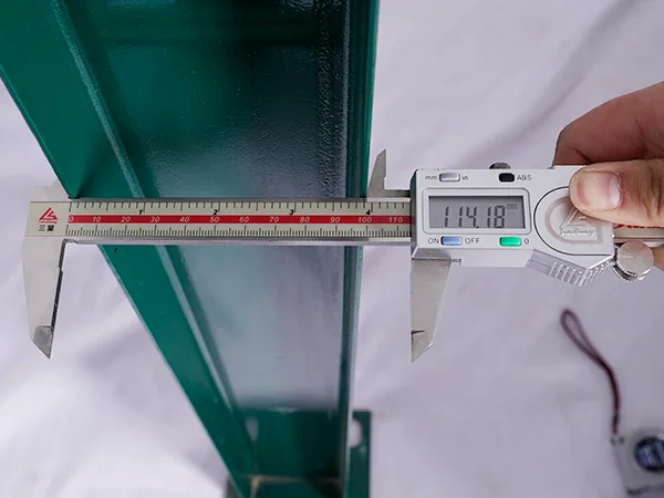 A QC worker is measuring the post size of palisade fence.
