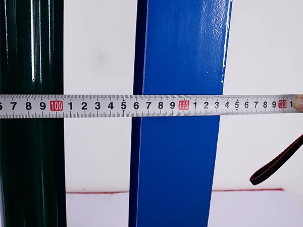A QC worker is measuring the fence width of palisade fence.