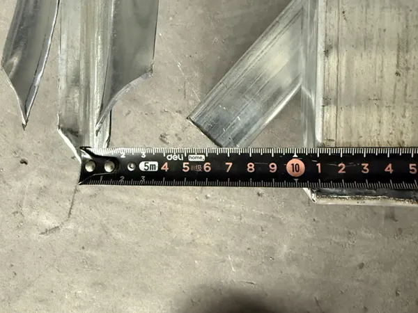 Workers measuring palisade fence panels