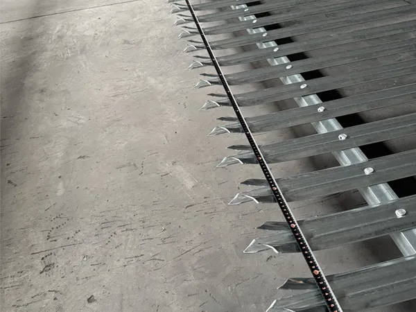 Workers measuring palisade fence panels