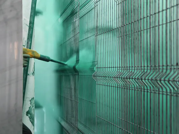 The details display of a machine applying power coating to a 3D fence panel.