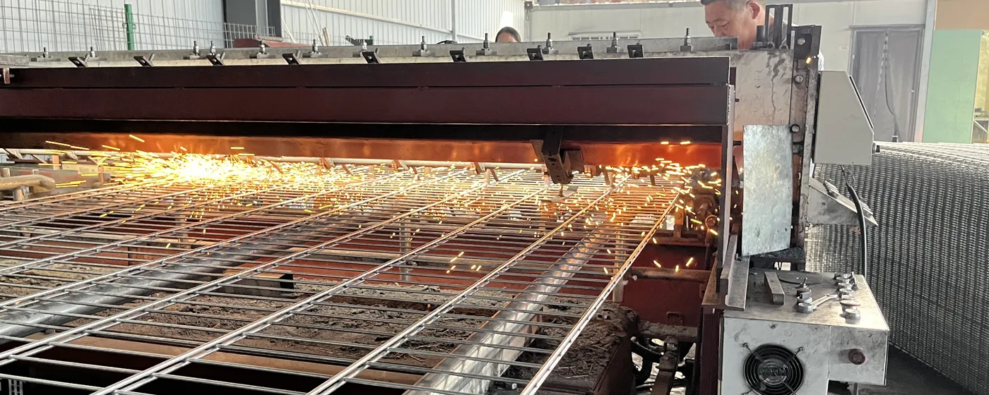 Privacy fence panels being welded on a production line.