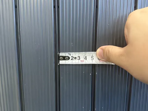 Width measurement of a privacy slat used in a privacy fence.