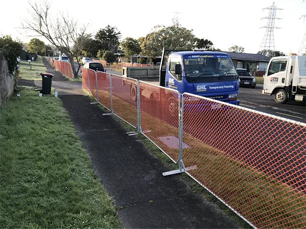 The PVC coated chain link temporary fencing panels are installed on the road.