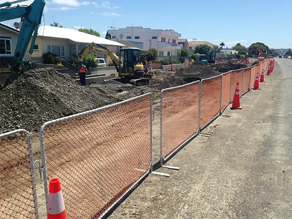 The PVC coated chain link temporary fencing panels are isolating the construction site and road.