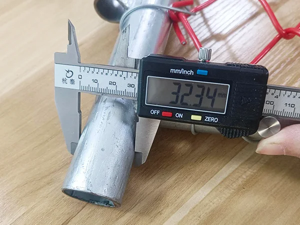 A QC worker is measuring the frame size of PVC coated New Zealand temporary fence.
