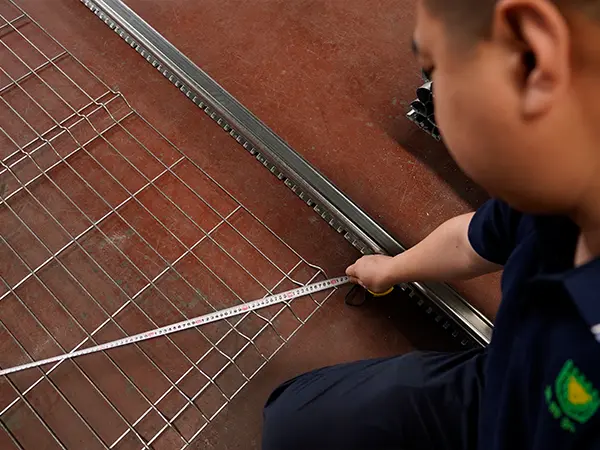A QC worker is inspecting the flatness of 3d mesh fence.