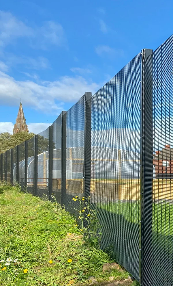 An airport is flying beyond the airport fence.