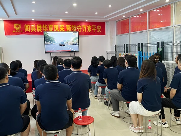 Team members are watching the broadcast of September 3rd Military Parade.