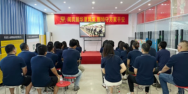 Team members are watching the broadcast of September 3rd Military Parade.