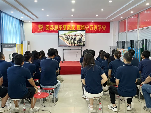 Team members are watching the broadcast of September 3rd Military Parade.
