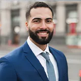 A Spain business man is smiling.