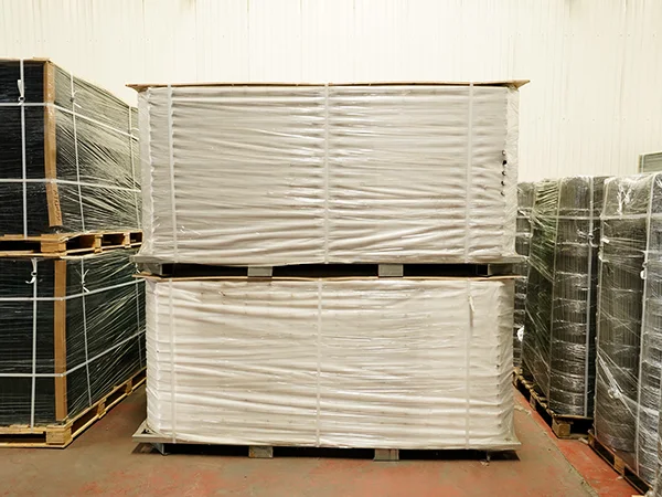 Several metal pallets of steel tubular fence panels in the warehouse.