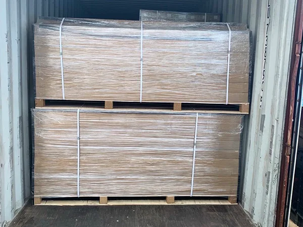 Several wooden pallets of steel tubular fence panels in the container.