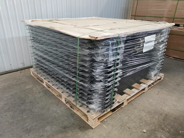 A wooden pallet of steel tubular fence panels with plastic film wrapped.