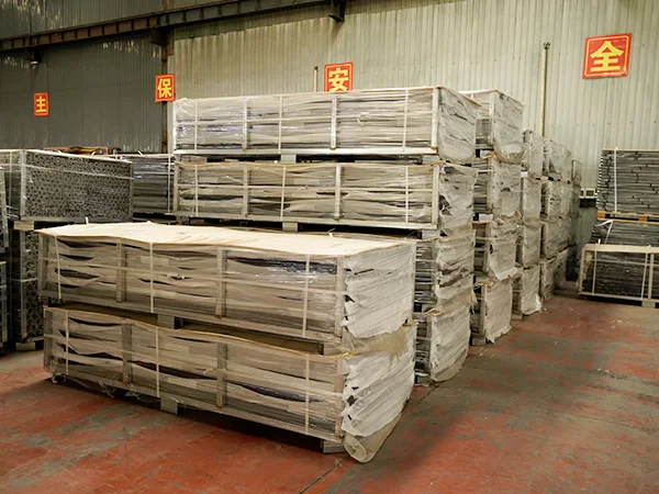 Several metal pallets of steel tubular fence post in the warehouse.
