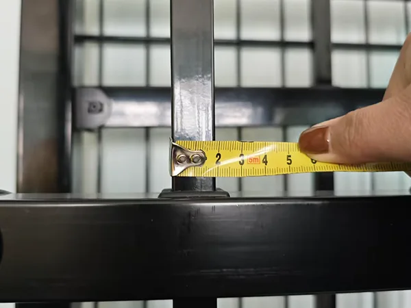 A QC worker is measuring the tubular size of steel tubular fence.