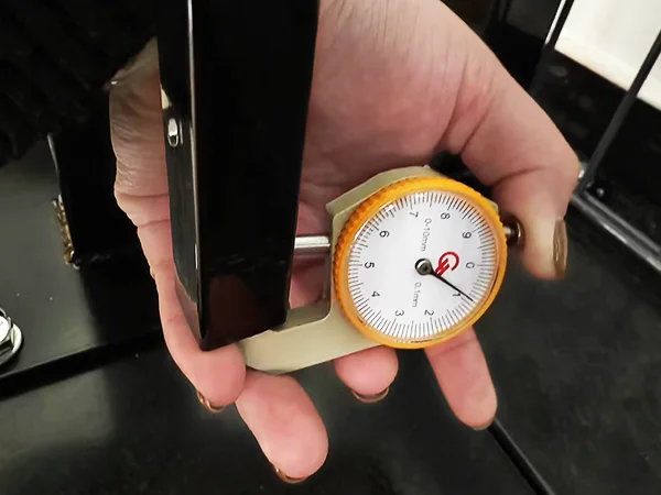 A QC worker is measuring the tubular thickness of steel tubular fence.