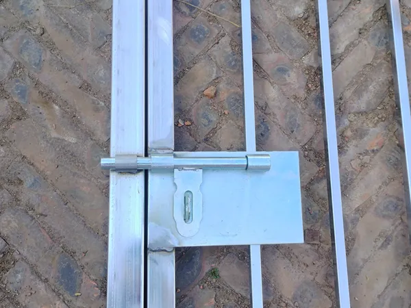 Detailed shot of slide bolt latch on galvanized steel tubular fencing gate