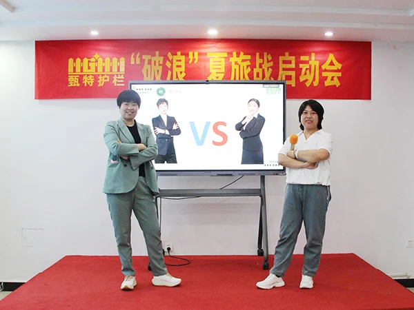Two sales manager taking photos at the front of the PK screen.