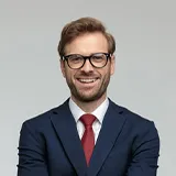 A USA business man is smiling.