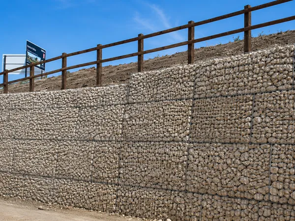 Welded Gabion large retaining wall along a roadway.