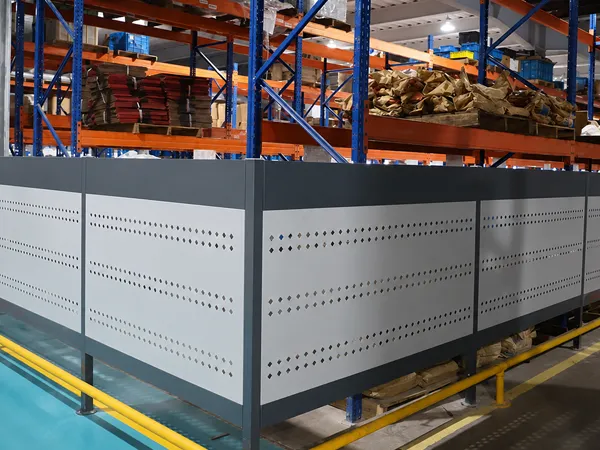 Workshop safety fence cultural guardrail protecting a warehouse work area.