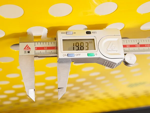A QC worker is measuring the hole size of all welded workshop safety fence.