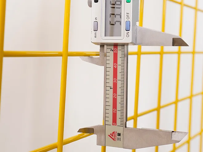 A QC worker is measuring the mesh size of all welded workshop safety fence.